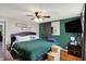 Comfortable primary bedroom offers a ceiling fan and television mounted on the wall at 3104 Poplar St, Anderson, IN 46012