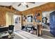 Bright sunroom with bookshelves, sliding glass door, and views of the outdoors at 3104 Poplar St, Anderson, IN 46012