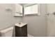 A well-lit bathroom features a vanity with a dark wood cabinet and a toilet at 3109 Forest Manor Ave, Indianapolis, IN 46218