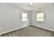 This cozy bedroom has two windows for natural light and plush gray carpeting at 3109 Forest Manor Ave, Indianapolis, IN 46218