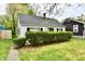 Charming one-story home with a manicured lawn, black shutters, and a gray roof in a beautiful, suburban setting at 3109 Forest Manor Ave, Indianapolis, IN 46218