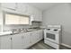 Well-lit kitchen featuring white cabinets, updated countertops, and a stainless steel sink at 3109 Forest Manor Ave, Indianapolis, IN 46218
