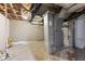 Unfinished basement with exposed pipes and concrete walls at 3421 Arthington Blvd, Indianapolis, IN 46218