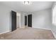 Bedroom featuring neutral carpet, gray walls, and closet at 3421 Arthington Blvd, Indianapolis, IN 46218