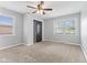 Bedroom featuring neutral carpet, gray walls, ceiling fan, and closet at 3421 Arthington Blvd, Indianapolis, IN 46218