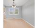 Open-concept dining room with light wood floors, a contemporary light fixture and gray walls at 3421 Arthington Blvd, Indianapolis, IN 46218