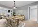 Bright dining room seamlessly connects to the living area, featuring a stylish light fixture and modern decor at 3421 Arthington Blvd, Indianapolis, IN 46218