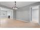 Open concept dining room with light wood floors, a modern light fixture, and gray walls at 3421 Arthington Blvd, Indianapolis, IN 46218