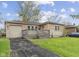 Charming home featuring a well-kept lawn, front porch, and a one-car garage enhancing its curb appeal at 3421 Arthington Blvd, Indianapolis, IN 46218