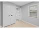 Hallway with gray walls, two closets, and an entry door at 3421 Arthington Blvd, Indianapolis, IN 46218