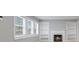 Cozy living room features a fireplace, built-in shelves, and natural light from three windows at 3421 Arthington Blvd, Indianapolis, IN 46218