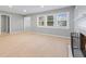Bright living room with light wood floors, large windows, neutral walls, and a modern fireplace at 3421 Arthington Blvd, Indianapolis, IN 46218