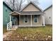 Charming two-story home with neutral colors, covered porch, and well-maintained front yard at 438 N Keystone Ave, Indianapolis, IN 46201