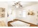 Cozy bedroom featuring hardwood floors, a ceiling fan, and decorative painted accents at 4406 Carrollton Ave, Indianapolis, IN 46205