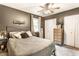 Comfortable bedroom featuring a ceiling fan, neutral decor, a double door closet, and a natural light window at 4406 Carrollton Ave, Indianapolis, IN 46205