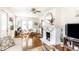 Spacious living room with modern furniture, a decorative fireplace, and hardwood floors at 4406 Carrollton Ave, Indianapolis, IN 46205