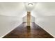 Attic with exposed brick pillar, natural light, and wood flooring at 4623 Evanston Ave, Indianapolis, IN 46205