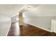 View of attic space featuring exposed brick pillar and wood flooring at 4623 Evanston Ave, Indianapolis, IN 46205