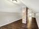 Open attic featuring exposed brick pillar and access to upper floors at 4623 Evanston Ave, Indianapolis, IN 46205