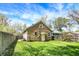 Backyard view of home featuring level lawn and privacy fence at 4623 Evanston Ave, Indianapolis, IN 46205
