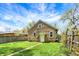 A charming tan house with a well-maintained lawn and a quaint backyard, perfect for outdoor relaxation at 4623 Evanston Ave, Indianapolis, IN 46205