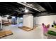 Wide view of basement; unfinished with visible utilities and black painted ceilings at 4623 Evanston Ave, Indianapolis, IN 46205