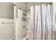 This full bath features a tiled shower with a decorative shower curtain at 4623 Evanston Ave, Indianapolis, IN 46205