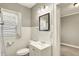This full bath has a sink and toilet with a decorative mirror and lighting at 4623 Evanston Ave, Indianapolis, IN 46205