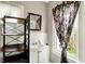 Bathroom featuring a stylish mirror, shelving, and floral curtains at 4623 Evanston Ave, Indianapolis, IN 46205