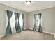 A bright bedroom with neutral carpet and beautiful curtains covering the windows at 4623 Evanston Ave, Indianapolis, IN 46205