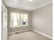 A simple bedroom with neutral walls and carpet and big windows for natural light at 4623 Evanston Ave, Indianapolis, IN 46205