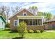 Charming home featuring a cozy front porch and a well-maintained lawn with fresh landscaping at 4623 Evanston Ave, Indianapolis, IN 46205