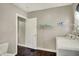 Another view of the laundry room with dark wood floors and a white door at 4623 Evanston Ave, Indianapolis, IN 46205