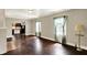 Spacious living room showcasing hardwood floors, neutral walls, and natural light, open to the kitchen at 4623 Evanston Ave, Indianapolis, IN 46205