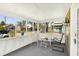 Relaxing screened-in porch with cozy seating, offering a tranquil outdoor living space with neighborhood views at 4623 Evanston Ave, Indianapolis, IN 46205