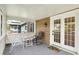 Cozy screened-in porch furnished with chairs and a small table for comfortable outdoor living and relaxing at 4623 Evanston Ave, Indianapolis, IN 46205
