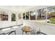 Bright screened porch offering an inviting space with seating and views of the surrounding neighborhood street at 4623 Evanston Ave, Indianapolis, IN 46205