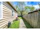 Side view of home and yard with wood fence and pathway at 4623 Evanston Ave, Indianapolis, IN 46205