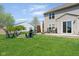Grassy backyard featuring a patio with outdoor seating and a fire pit with chairs at 4625 Elkhorn Ct, Noblesville, IN 46062