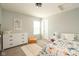 Bright bedroom featuring a window, neutral wall, and stylish decor at 4625 Elkhorn Ct, Noblesville, IN 46062