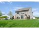 View of the home's exterior with a patio, outdoor furniture, and a lush green lawn at 4625 Elkhorn Ct, Noblesville, IN 46062