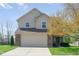 Charming two-story home featuring a brick and vinyl facade, attached garage, and well-manicured lawn at 4625 Elkhorn Ct, Noblesville, IN 46062
