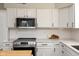 Well-equipped kitchen with white cabinets, subway tile backsplash, and stainless steel appliances at 4625 Elkhorn Ct, Noblesville, IN 46062