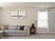 Comfortable living room featuring a gray sectional sofa, neutral walls and stylish decor at 4625 Elkhorn Ct, Noblesville, IN 46062