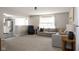 Spacious living room with a plush gray sofa, recliner, neutral walls, and large windows at 4625 Elkhorn Ct, Noblesville, IN 46062