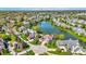 Picturesque aerial view of a lakeside community, showcasing beautiful homes with mature trees and landscaping at 4726 Ellery Ln, Indianapolis, IN 46250