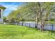 Expansive backyard features a metal fence separating the lawn from the lake beyond at 4726 Ellery Ln, Indianapolis, IN 46250