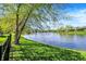 Well-manicured lawn leads to a picturesque lake view in this lush, green backyard at 4726 Ellery Ln, Indianapolis, IN 46250