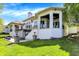 Exterior of the home highlighting a covered patio, outdoor firepit, and manicured lawn at 4726 Ellery Ln, Indianapolis, IN 46250