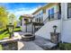 Backyard patio features a stone firepit, manicured landscaping and steps up to a covered patio at 4726 Ellery Ln, Indianapolis, IN 46250